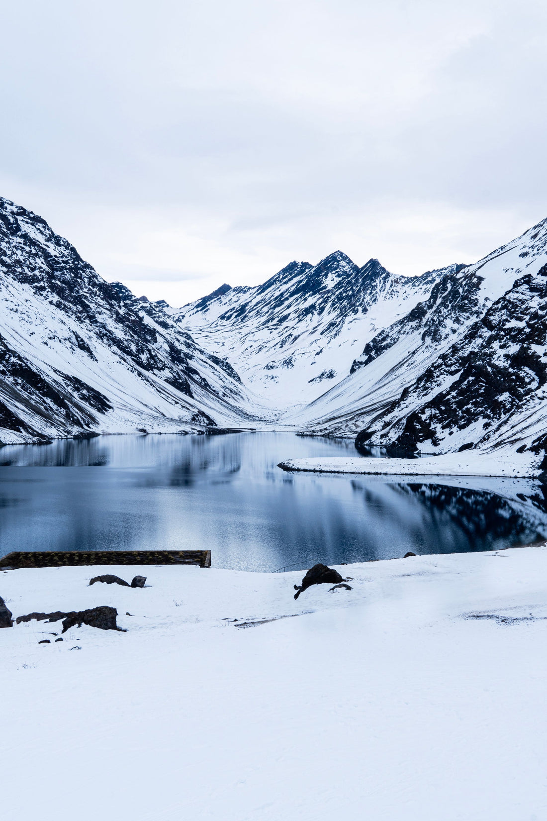 Snow-covered mountains and lake at Portillo, Chile.