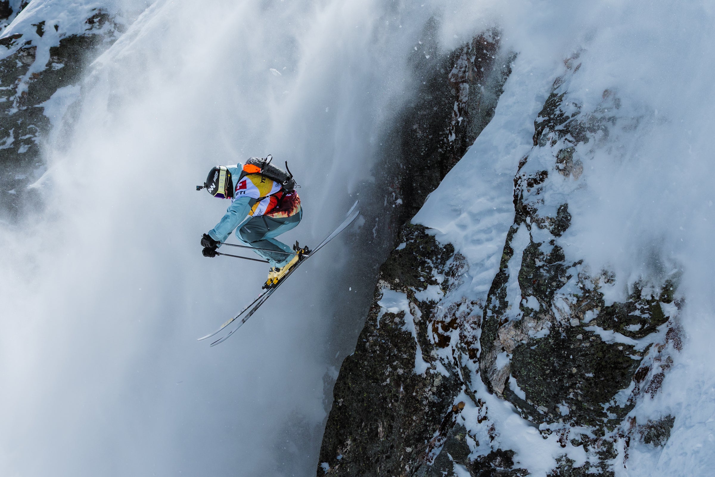 Skier airborne beside a steep rock wall at Verbier, photographed by Jeremy Bernard at the 2026 Freeride World Tour